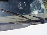 a white van with a sticker on the windshield of it