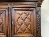 a large wooden cabinet with two doors on top of it