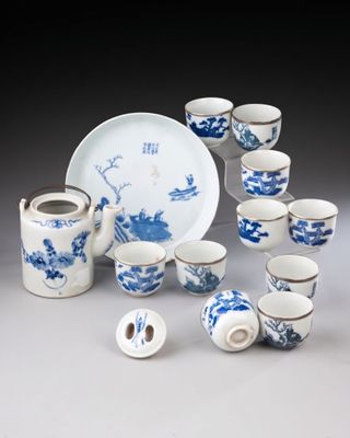 a lot of blue and white cups and saucers on the table