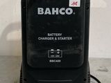an electric charger is sitting on the floor next to a wall