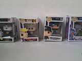 a group of three pop vinyl figures sitting on top of a table