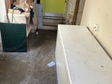 an image of a room that has a refrigerator and a refrigerator freezer in it