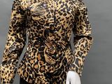 a mannequin wearing a leopard print top and black pants