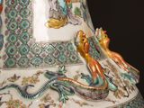 a vase with a picture of a man and a dragon on it
