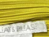 the label of a yellow dress with a white label on it