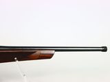 a rifle on a stand with a white background