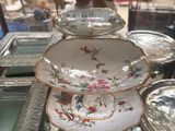 a glass display case with plates and bowls on it