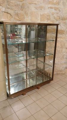 a glass display case in the corner of a room