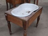 a white sink sitting on top of a wooden table