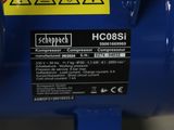 a close up of a blue compressor with a yellow label on it