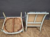 two chairs sitting next to each other on a wooden floor