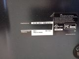 a label on the back of a black refrigerator