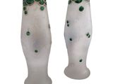 pair of glass vases with green dots on them on a white background