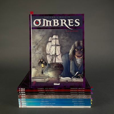 books stacked on top of each other in front of a gray background