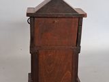 an image of a small wooden cabinet with a door on the top