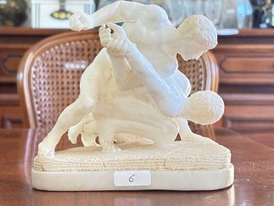 a figurine of a man riding a bull on a table