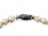 an image of a bracelet with pearls and a black bead