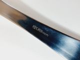 a knife that is sitting on a white table