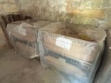 many mattresses wrapped up in plastic in a room