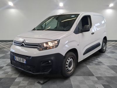 the white van is parked on a checkered floor in a room
