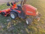 a red tractor that is sitting in the grass
