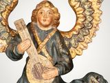 statue of an angel with a guitar on a gray background