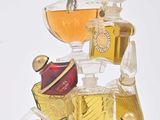 bottles of perfume are stacked on top of each other on a white surface