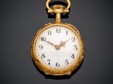 a close up of a gold pocket watch on a black background