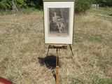 a picture of a painting on a easel in a field