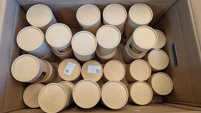 a cardboard box full of empty cups and lids