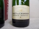 a bottle of champagne sitting next to a bottle of wine