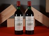 two bottles of wine sitting next to each other on a table
