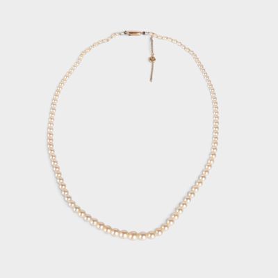 a white pearl necklace with a gold clasp on a white background