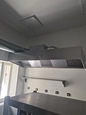 a kitchen with a stove, oven, and a window