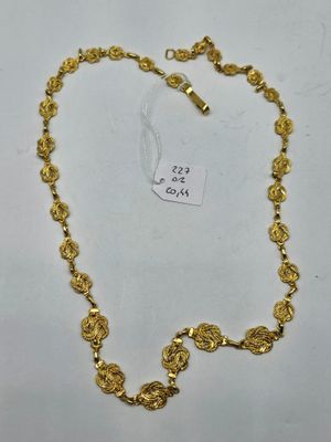 a gold necklace with a heart shaped clasp