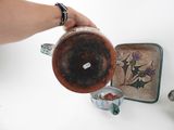 a person that is pouring something into a cup