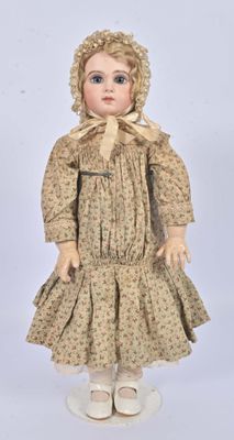 an old fashioned doll with a bonnet and dress on it ' s head