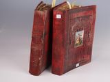 pair of red leather books with pictures of a man and a woman on them
