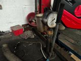 a gauge that is connected to a pipe in a garage