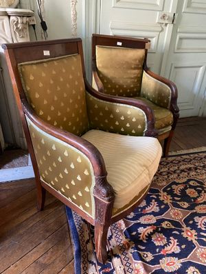 two chairs in a room with a rug on the floor