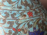 a blue and gold vase sitting on a table