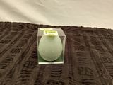 a white candle that is sitting on a brown blanket