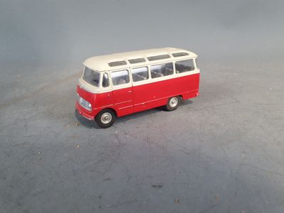 a red and white toy bus on a gray surface