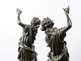 statue of two women with hands up in the air