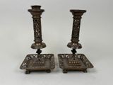 pair of antique brass candlesticks with ornate design