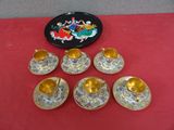 six cups and saucers are sitting on a red table cloth