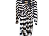 striped dress with black and white stripes on a hanger on a white background