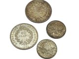 four different types of coins on a white background