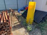 a pile of pipes and a yellow pole in the yard