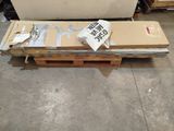 a box with a sign on it sitting on a pallet in a warehouse